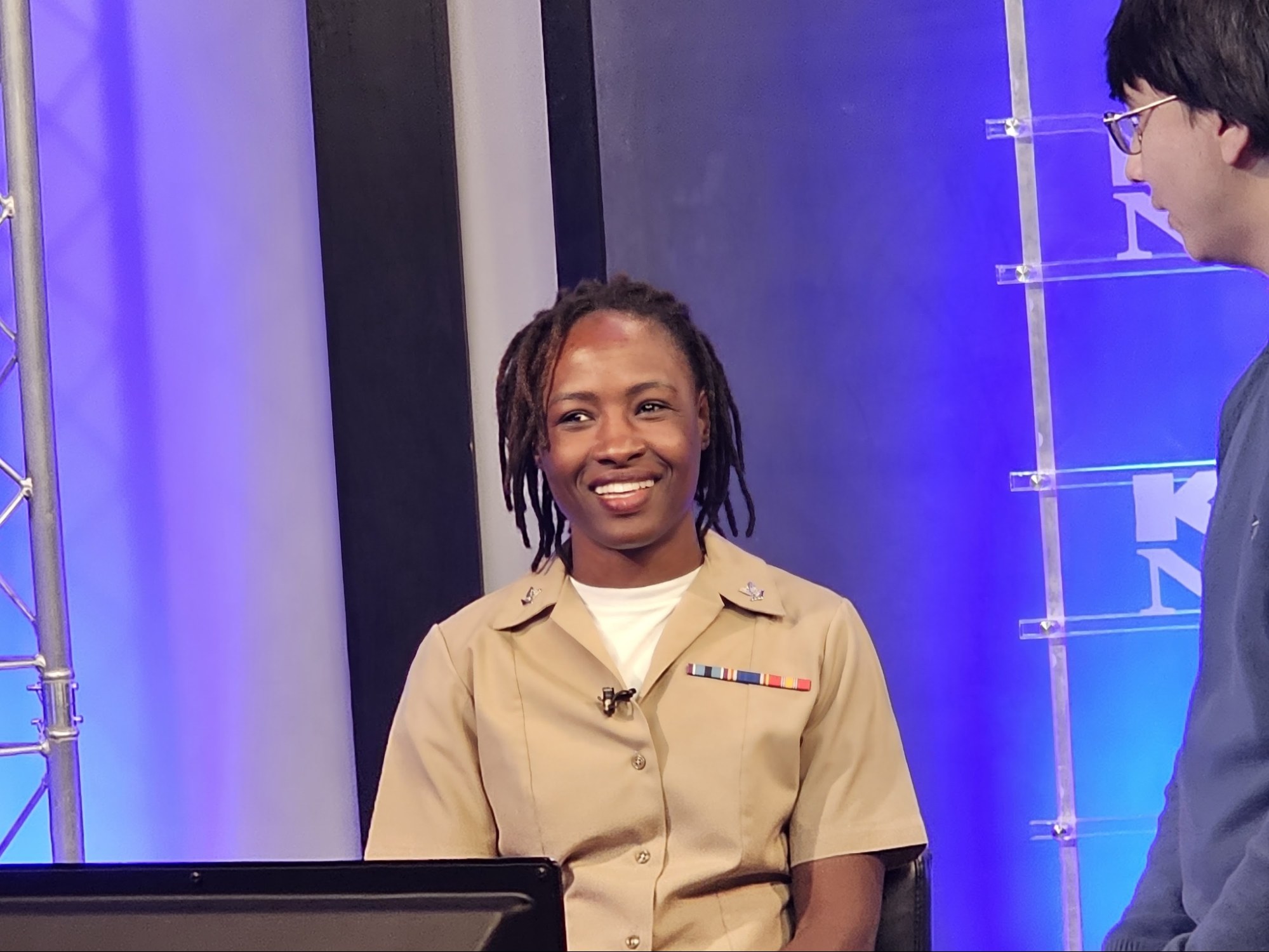 Rejoice Tapon in Navy Hospital Corpsman uniform interviewed on TV