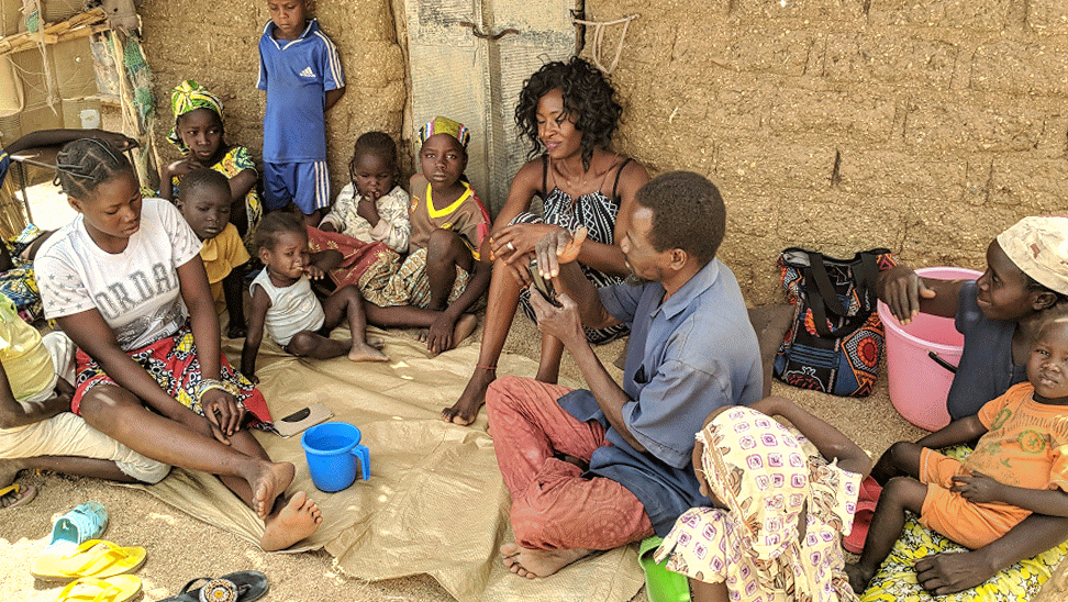 Houloum villagers gather around.