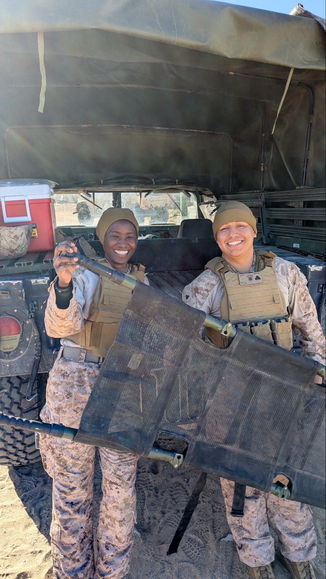 Corpsmen with a stretcher, ready to haul casualties in the desert.